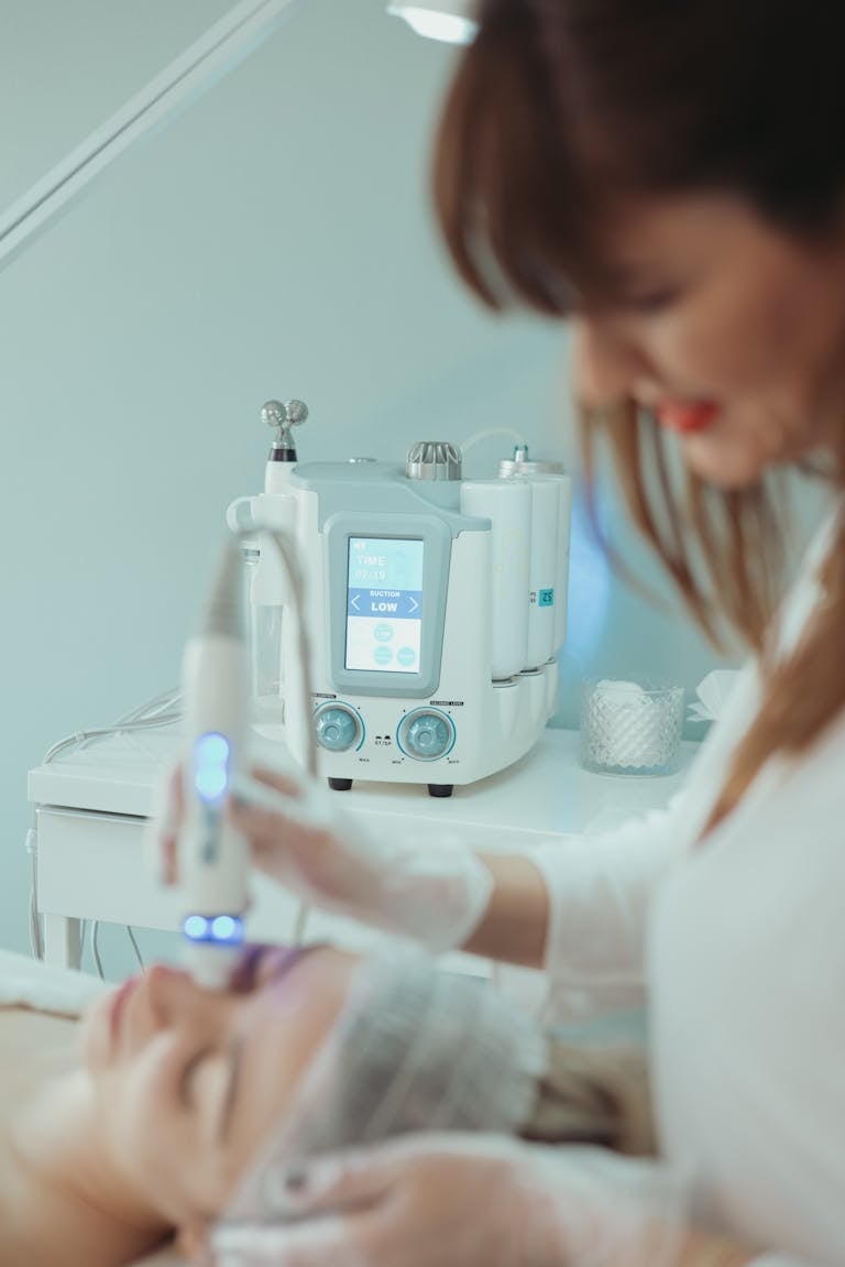 Close-up of a hydrafacial treatment being applied in a modern beauty clinic.