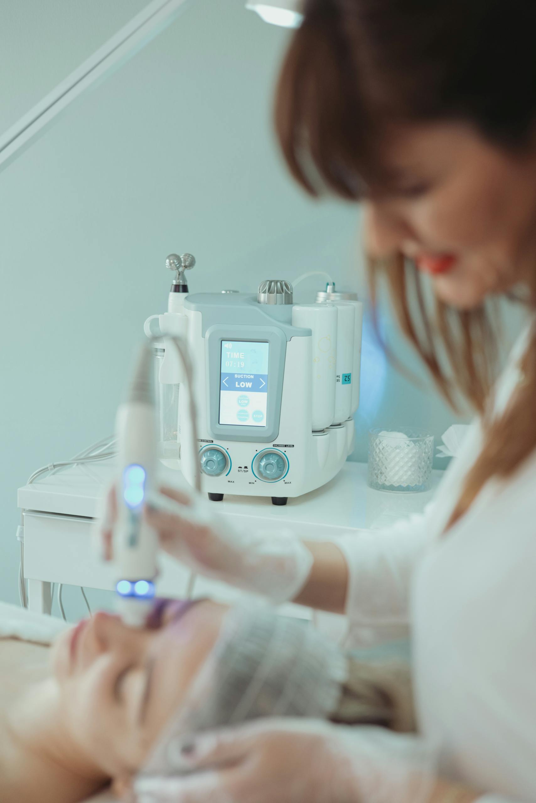 Close-up of a hydrafacial treatment being applied in a modern beauty clinic.